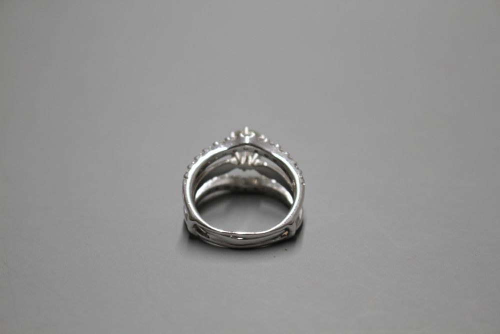 A modern 14kt white metal and triple band diamond dress ring,